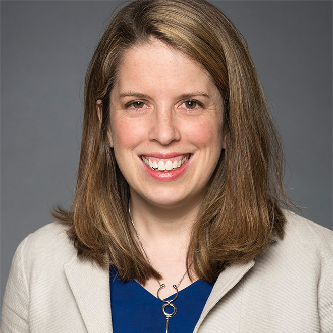 a person with long hair smiling
