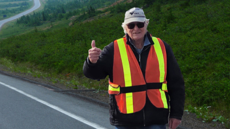 a man wearing a safety vest and holding up his thumb